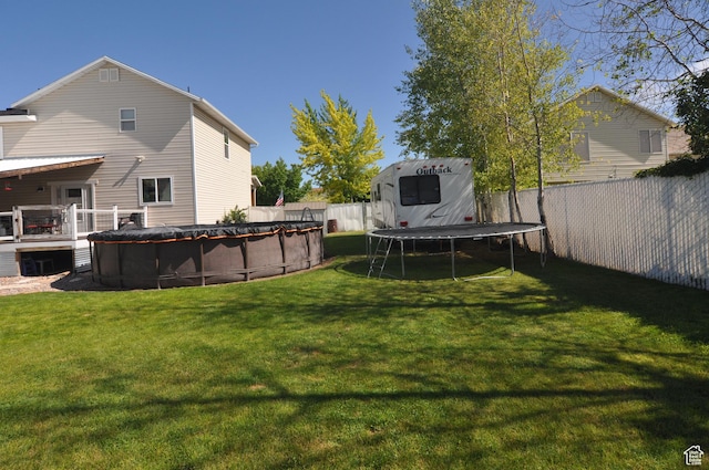 2857 W 2250 N, Clinton, UT 84015 - fenced backyard featuring a trampoline and a deck