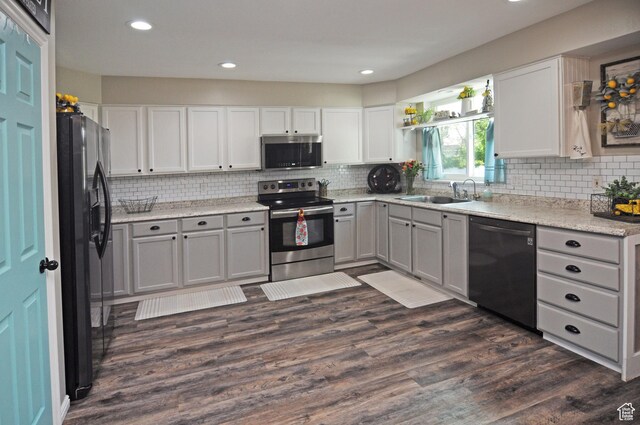 2857 W 2250 N, Clinton, UT 84015 - kitchen with stainless steel appliances, dark wood finished floors, tasteful backsplash, recessed lighting, and white cabinetry