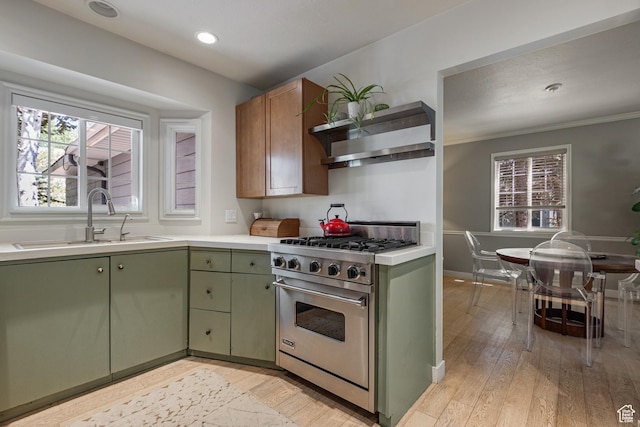 2442 Lily Langtry Ct, Park City, UT 84060 - kitchen featuring premium stove, green cabinetry, light countertops, wall chimney exhaust hood, and light wood-type flooring