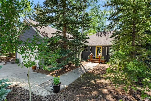 2442 Lily Langtry Ct, Park City, UT 84060 - obstructed view of property with a shingled roof and a garage