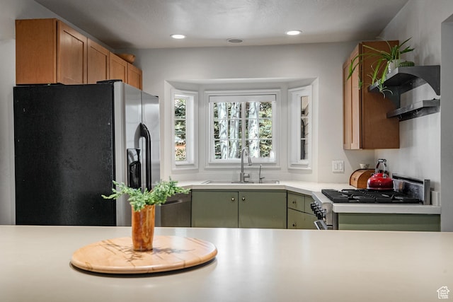 2442 Lily Langtry Ct, Park City, UT 84060 - kitchen with fridge with ice dispenser, range, light countertops, recessed lighting, and green cabinetry