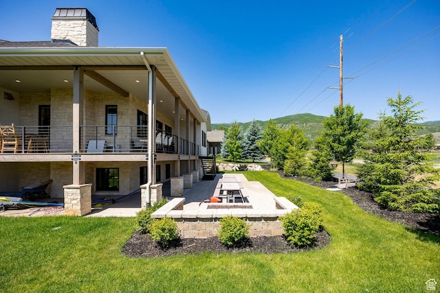 905 S Coldwater Way, Midway, UT 84049 - view of green lawn with a patio area, a mountain view, an outdoor fire pit, and a balcony