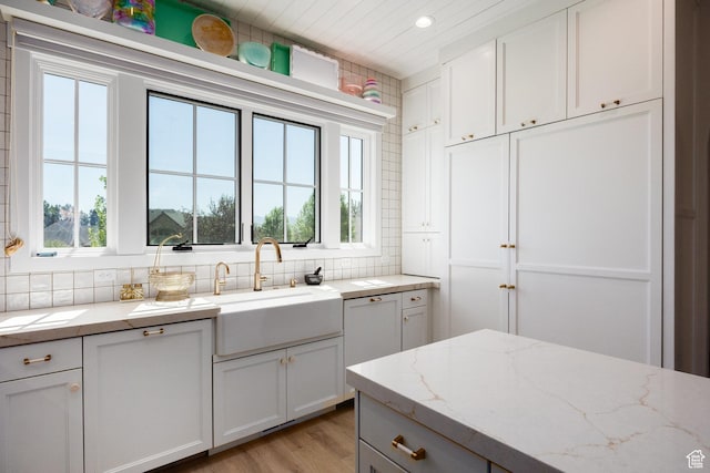 905 S Coldwater Way, Midway, UT 84049 - kitchen with backsplash, recessed lighting, light wood-style floors, white cabinetry, and light stone counters