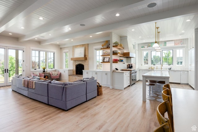 905 S Coldwater Way, Midway, UT 84049 - living area featuring light wood finished floors, a fireplace, recessed lighting, plenty of natural light, and french doors