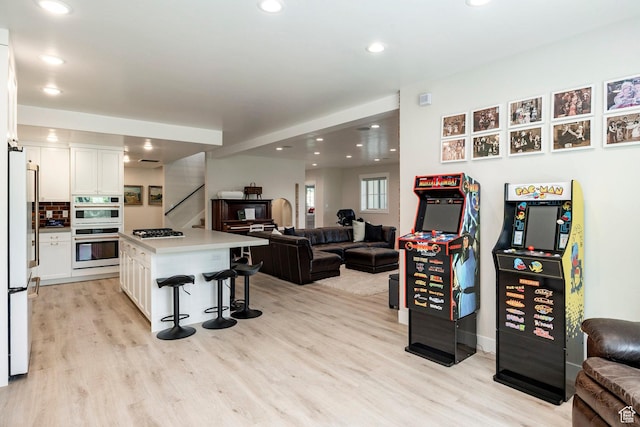905 S Coldwater Way, Midway, UT 84049 - kitchen with double oven, freestanding refrigerator, gas stovetop, open floor plan, and light wood-style floors