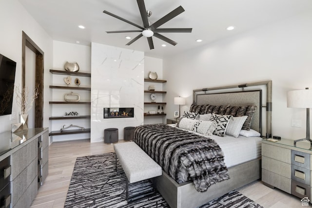 13202 N Alexis Dr, Heber City, UT 84036 - bedroom with light wood finished floors, recessed lighting, and a fireplace