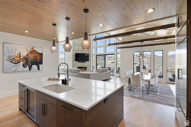 13202 N Alexis Dr, Heber City, UT 84036 - kitchen with wood ceiling, healthy amount of natural light, wine cooler, light wood-style flooring, and light countertops