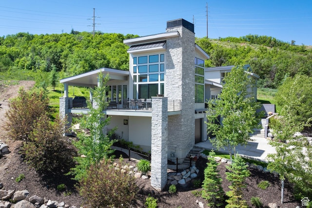 13202 N Alexis Dr, Heber City, UT 84036 - view of home's exterior with a chimney and a balcony