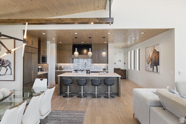 13202 N Alexis Dr, Heber City, UT 84036 - kitchen featuring exhaust hood, modern cabinets, recessed lighting, a breakfast bar area, and light wood-style flooring