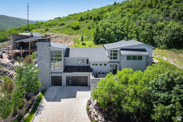 13202 N Alexis Dr, Heber City, UT 84036 - modern home featuring driveway, a garage, a metal roof, a standing seam roof, and a chimney