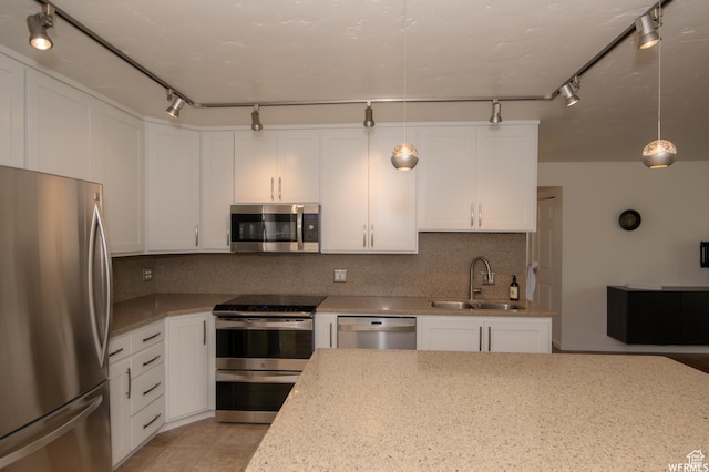 115 S 1100 E, Salt Lake City, UT 84102 - kitchen with appliances with stainless steel finishes, white cabinetry, tasteful backsplash, pendant lighting, and light stone countertops