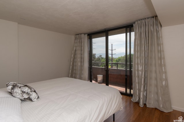 115 S 1100 E, Salt Lake City, UT 84102 - bedroom featuring access to exterior, wood finished floors, and a wall of windows