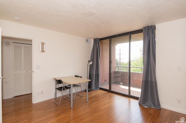 115 S 1100 E, Salt Lake City, UT 84102 - unfurnished room with wood finished floors, expansive windows, and a smoke detector