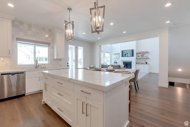 1114 N Oxborrow Dr, Lehi, UT 84043 - kitchen featuring stainless steel dishwasher, a kitchen island, wood finished floors, recessed lighting, and backsplash