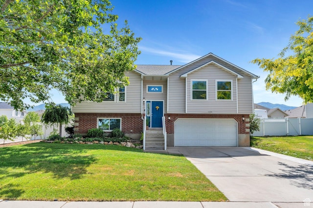 1666 N 160 W, Layton, UT 84041 - raised ranch featuring an attached garage, driveway, and brick siding