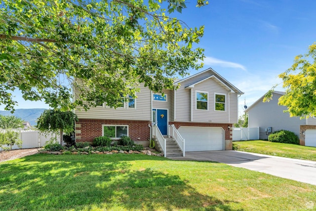 1666 N 160 W, Layton, UT 84041 - view of front facade with brick siding, an attached garage, and concrete driveway