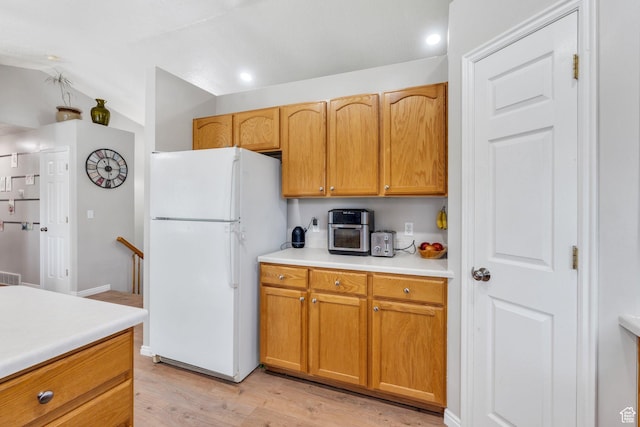 1666 N 160 W, Layton, UT 84041 - kitchen with freestanding refrigerator, light wood-style floors, light countertops, vaulted ceiling, and recessed lighting