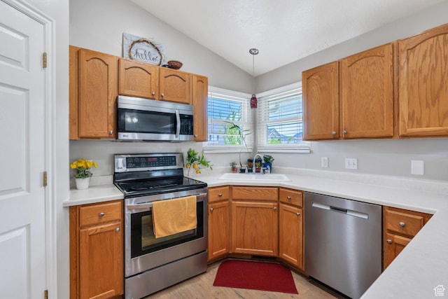 1666 N 160 W, Layton, UT 84041 - kitchen featuring stainless steel appliances, lofted ceiling, light countertops, light wood-type flooring, and decorative light fixtures