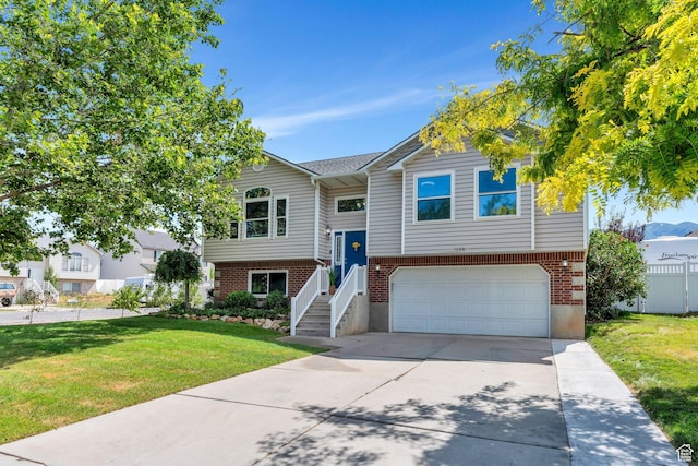 1666 N 160 W, Layton, UT 84041 - split foyer home featuring a garage, concrete driveway, a front yard, and brick siding