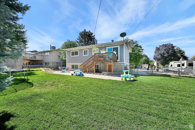 604 W 1750 N, Clinton, UT 84015 - back of property featuring a trampoline, a patio, stairway, and a fenced backyard