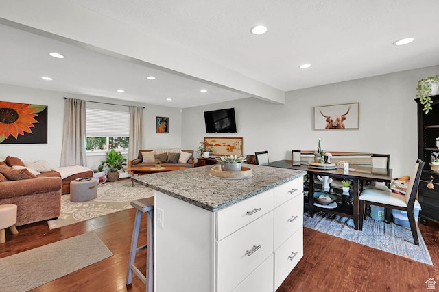 604 W 1750 N, Clinton, UT 84015 - kitchen with dark wood-type flooring, a kitchen bar, a center island, white cabinetry, and open floor plan