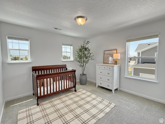 998 W 850 S, Springville, UT 84663 - bedroom with light carpet, a crib, and a textured ceiling