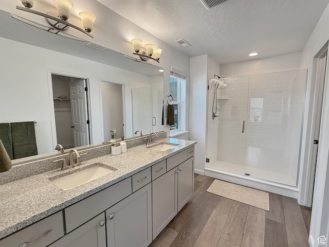 998 W 850 S, Springville, UT 84663 - bathroom with wood finished floors, a stall shower, double vanity, recessed lighting, and a walk in closet