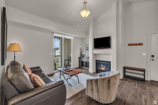 1043 S 500 E Unit G304, Heber City, UT 84032 - living area with a glass covered fireplace, dark wood-style floors, and high vaulted ceiling