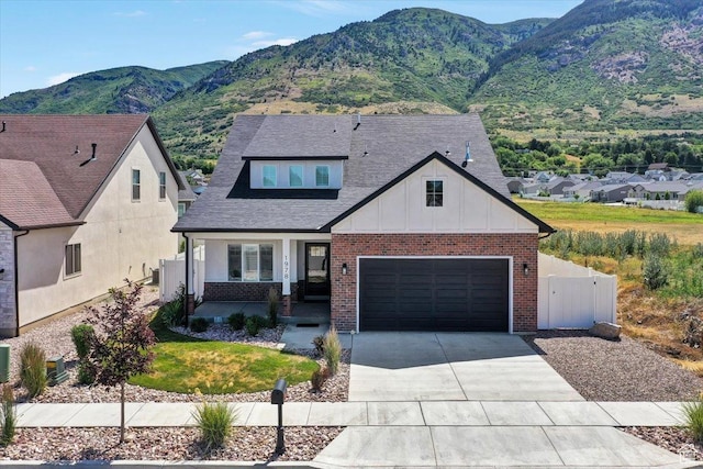 1978 N 840 E, North Ogden, UT 84414 - view of front facade with a porch, driveway, a mountain view, board and batten siding, and brick siding