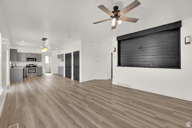 3482 E Kennekuk Cir, Eagle Mountain, UT 84005 - unfurnished living room featuring a ceiling fan, light wood-style flooring, and recessed lighting
