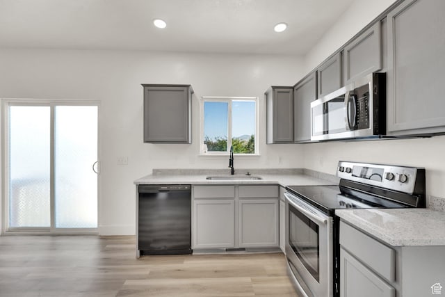 3482 E Kennekuk Cir, Eagle Mountain, UT 84005 - kitchen featuring appliances with stainless steel finishes, gray cabinetry, plenty of natural light, and recessed lighting