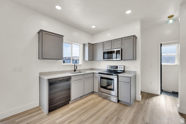 3482 E Kennekuk Cir, Eagle Mountain, UT 84005 - kitchen featuring stainless steel appliances, gray cabinets, light wood finished floors, light countertops, and recessed lighting