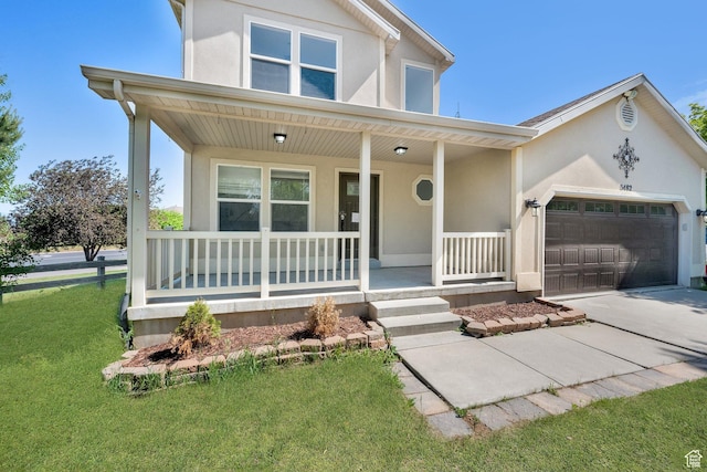 3482 E Kennekuk Cir, Eagle Mountain, UT 84005 - view of front facade with a porch, stucco siding, a garage, concrete driveway, and a front lawn