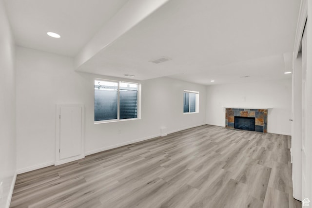 3482 E Kennekuk Cir, Eagle Mountain, UT 84005 - unfurnished living room with healthy amount of natural light, light wood-style floors, a fireplace, and recessed lighting