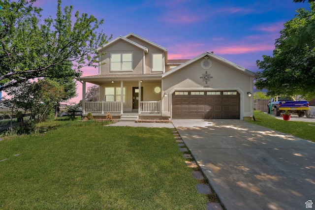 3482 E Kennekuk Cir, Eagle Mountain, UT 84005 - traditional home featuring a porch, stucco siding, driveway, and a front lawn