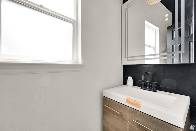 3482 E Kennekuk Cir, Eagle Mountain, UT 84005 - bathroom featuring vanity and decorative backsplash