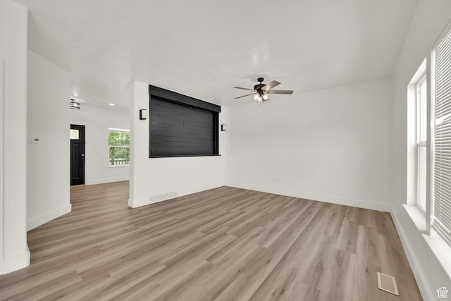 3482 E Kennekuk Cir, Eagle Mountain, UT 84005 - unfurnished living room featuring a ceiling fan and light wood-style flooring