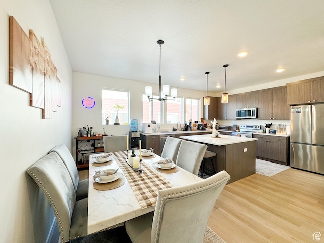 4721 W Talavara Way S, Kearns, UT 84118 - dining space featuring light wood-style floors, a chandelier, and recessed lighting