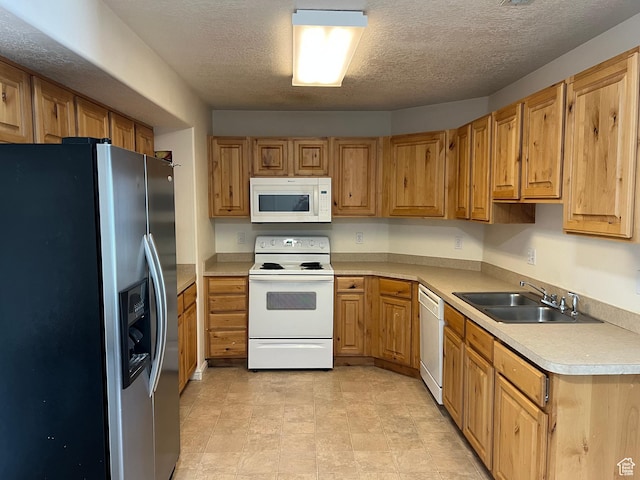 8228 N Cedar Rd Unit 11, Eagle Mountain, UT 84005 - kitchen featuring white appliances, light countertops, a textured ceiling, and brown cabinetry