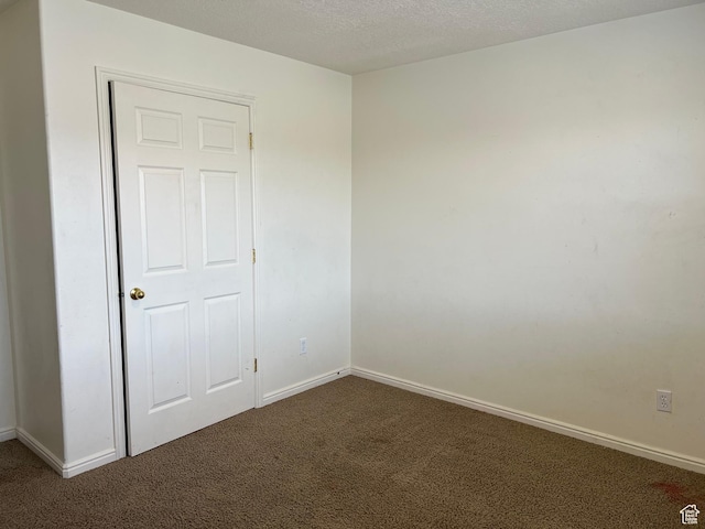 8228 N Cedar Rd Unit 11, Eagle Mountain, UT 84005 - unfurnished room featuring carpet floors and a textured ceiling