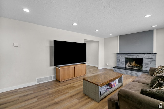 2234 W 300 N, West Point, UT 84015 - living area featuring a textured ceiling, a fireplace, light wood-type flooring, and recessed lighting
