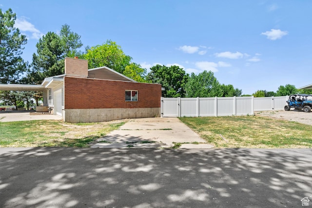 2234 W 300 N, West Point, UT 84015 - view of property exterior featuring a gate, a chimney, and an attached garage