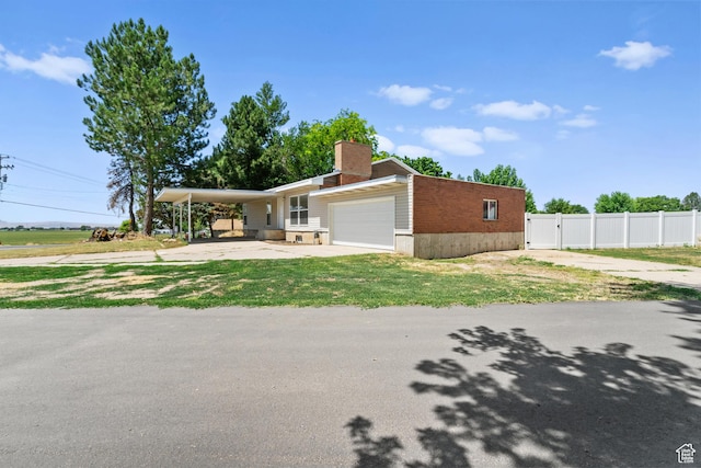 2234 W 300 N, West Point, UT 84015 - view of front of house with concrete driveway, an attached garage, a chimney, brick siding, and a gate