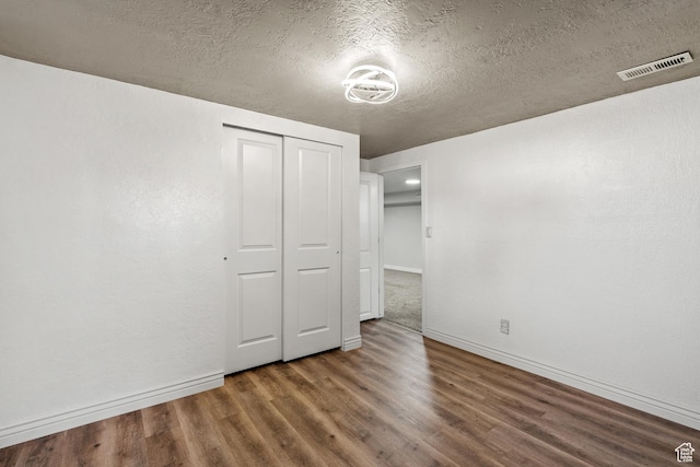2234 W 300 N, West Point, UT 84015 - unfurnished bedroom featuring wood finished floors, a textured ceiling, and a closet