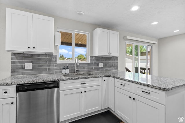2234 W 300 N, West Point, UT 84015 - kitchen featuring stainless steel dishwasher, a peninsula, white cabinets, tasteful backsplash, and light stone countertops