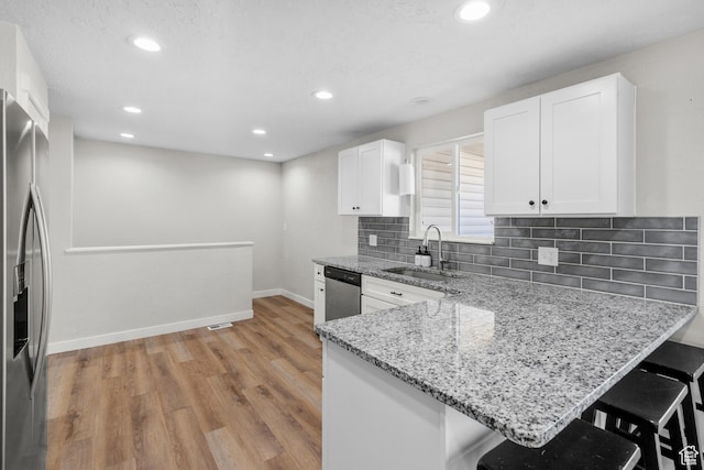 2234 W 300 N, West Point, UT 84015 - kitchen featuring stainless steel appliances, light wood finished floors, a kitchen breakfast bar, white cabinetry, and recessed lighting