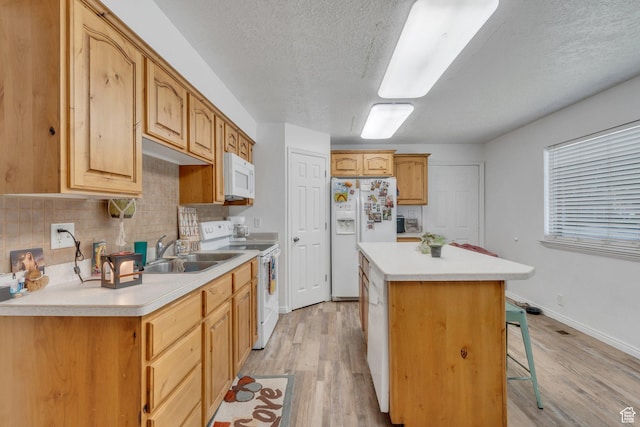 197 E Utah Ave, Payson, UT 84651 - kitchen with white appliances, a center island, light wood-style floors, a breakfast bar area, and a textured ceiling