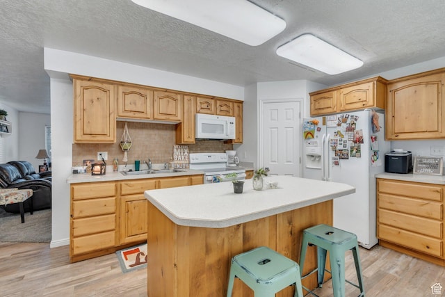 197 E Utah Ave, Payson, UT 84651 - kitchen with white appliances, light countertops, light wood finished floors, backsplash, and a textured ceiling