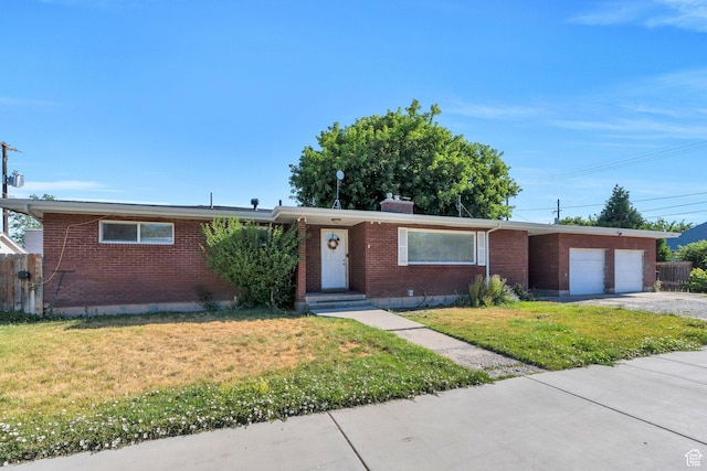 197 E Utah Ave, Payson, UT 84651 - ranch-style home with an attached garage, brick siding, concrete driveway, and a front lawn