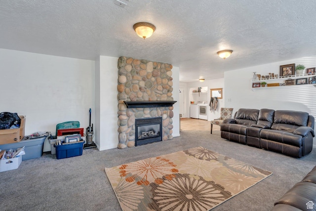 197 E Utah Ave, Payson, UT 84651 - living room with carpet flooring, washing machine and clothes dryer, a textured ceiling, and a stone fireplace